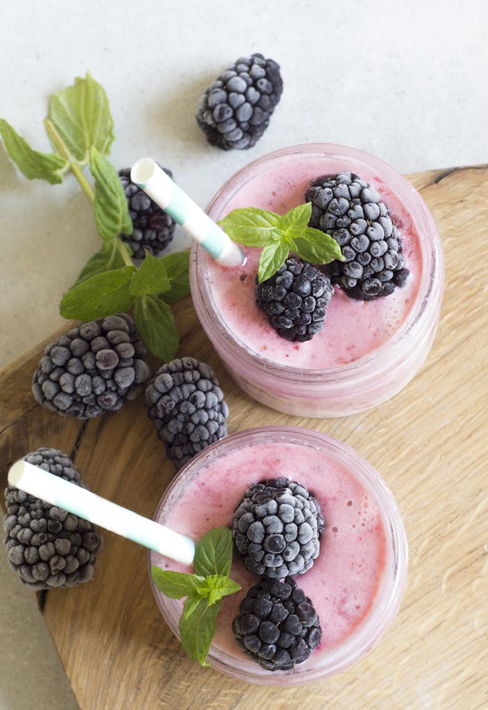 Home Enjoy a refreshing blackberry smoothie topped with fresh mint leaves, perfect for a summer treat.